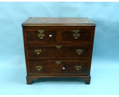 A Georgian walnut crossbanded Chest of Drawers, with two short and two long drawers, with brass handles and escutcheon's, rai