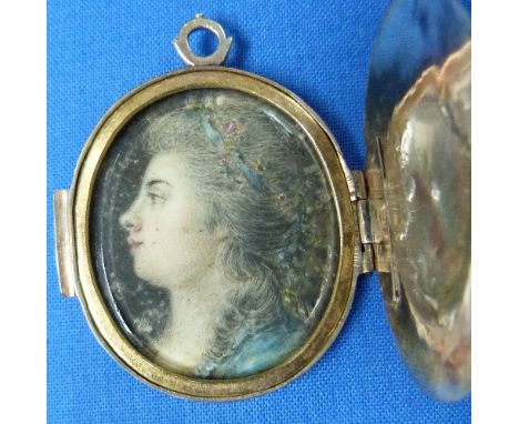 A gilt metal oval Locket, with gold detail, the interior set with a portrait miniature on ivory of a Georgian lady facing sin