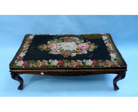 A 19thC tapestry Stool, the ornately carved mahogany frame raised on cabriole legs, upholstered with floral wool-work tapestr