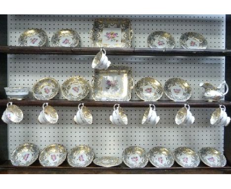 A Grosvenor porcelain Tea Service, grey and gold with pink floral central sprays, inlcuding eight cups and saucers, eight tea