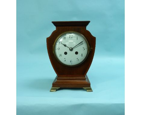 An Edwardian inlaid mahogany shield shaped Mantel Clock, the eight day movement striking on a gong, with flat top upon gilt m