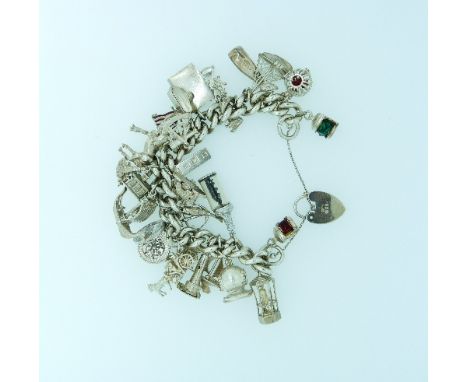 A silver link Bracelet, with many interesting silver charms suspended, including port and starboard lights, 'Jonah and the Wh