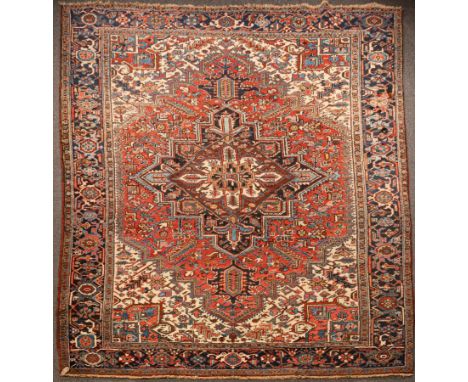 A Heriz carpet, North West Persia, late 20th Century, the madder field centred by an indigo medallion with graduated spandrel