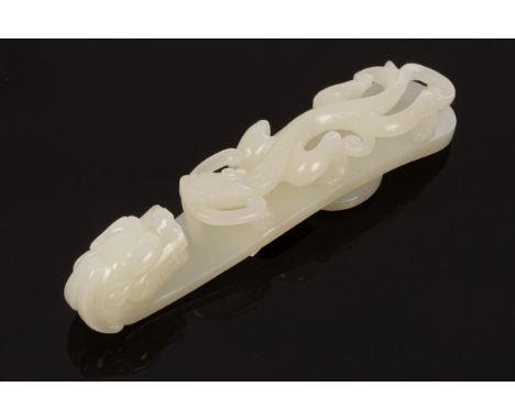 A Chinese white jade carved belt hook, Qing, in the form of a dragon, 12cm long CONDITION REPORT: In very good condition 624.