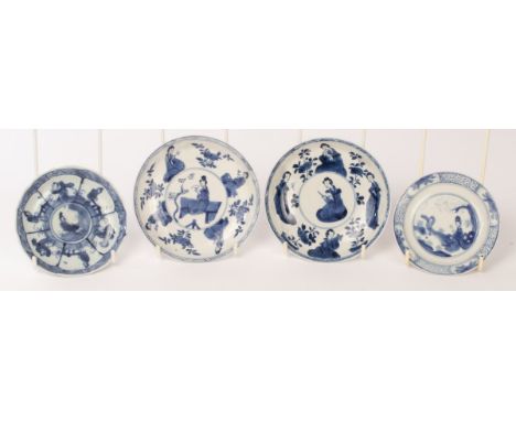 Four Chinese blue and white porcelain saucers, Kangxi, the two bigger ones decorated with ladies admiring flowers or playing 