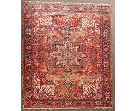 A Heriz carpet, North-West Persia, with a madder field, medallion and samovar border, 341cm x 240cm  CONDITION REPORT: Condit