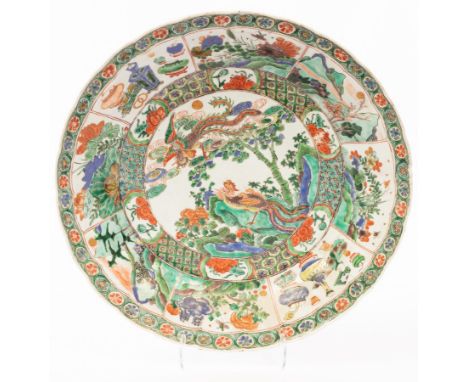 A famille verte circular dish, Qing dynasty, Kangxi period, painted to the interior with two phoenix in a garden, 35cm diamet