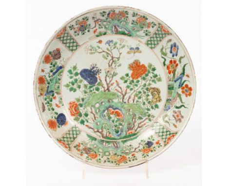 A famille verte circular dish, Qing dynasty, Kangxi period, painted to the interior with peony amongst garden rocks, 35cm dia