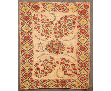 A Nurata Suzani, Uzbekistan, the pale sand cotton field with a floral medallion and floral sprays, framed by a lattice serrat