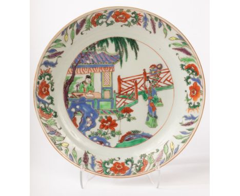 A Chinese famille vert plate, Kangxi, decorated with figures inside and outside in the garden, depicting the story of Xi Xian