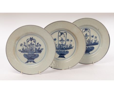 Three blue and white circular dishes, Qing dynasty, Kangxi period, each painted with baskets of flowers and covered everted r