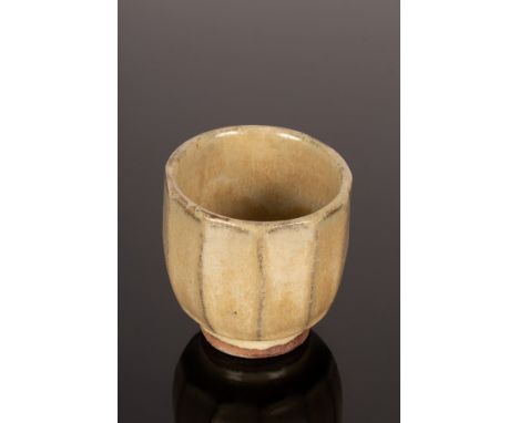 Jim Malone (born 1947), a cut sided stoneware pot with faceted sides and glazed exterior, potter's mark to foot rim, 9.5cm hi