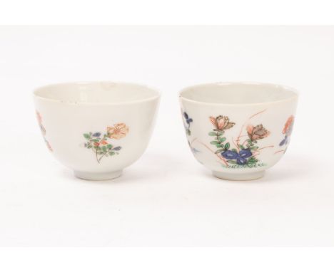 A near pair of wucai wine cups, Qing dynasty, Kangxi period, each painted with flowers, seal marks to base, 6cm diameter (2)/