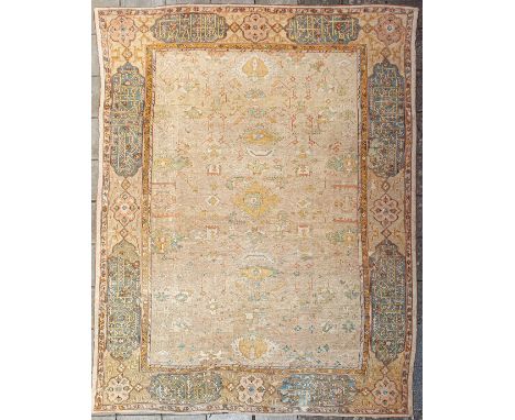 A large Ushak Carpet, West Anatolia, circa 1900, with a soft sand field and an all over design of stylised flowerhead and vin