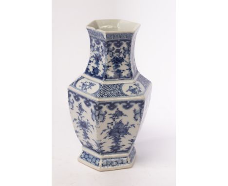 A Chinese hexagonal blue and white porcelain vase, Qing Dynasty, decorated with patterns of ruyi clouds, peaches, pomegranate