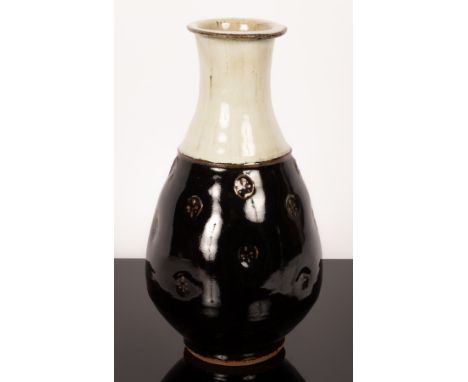 Jim Malone (born 1946), a Korean footed bottle, decorated segmented contrasting colours and impressed details, tenmoku glaze,