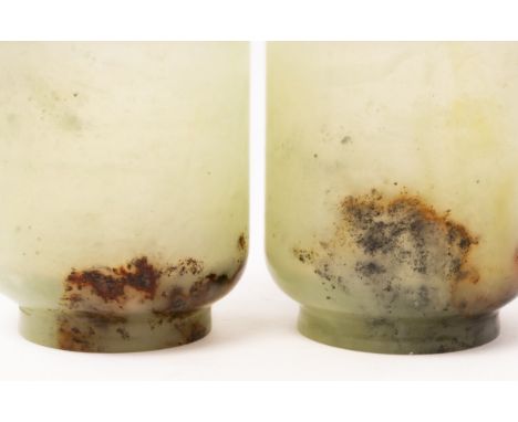A pair of Chinese celadon jade tea cups, 19th/20th Century, finely carved to semi-transparency, brown and black russet patche