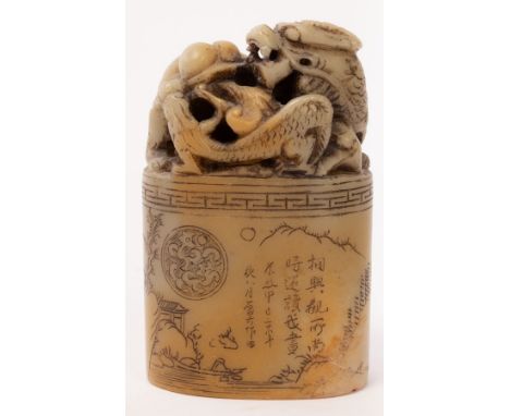 A Chinese Shoushan stone carved seal Longfei, Qing Dynasty, decorated with a relief of figures in a landscape, the finial of 
