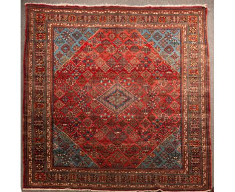 A Joshagan carpet, North West Persia, the madder field with an open trellis design of floral lozenges, centred by a sea blue 