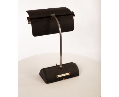 A metal desk lamp, the textured aluminium articulated shade on chrome painted arm, Solite label to base, stamped No. 1411 to 