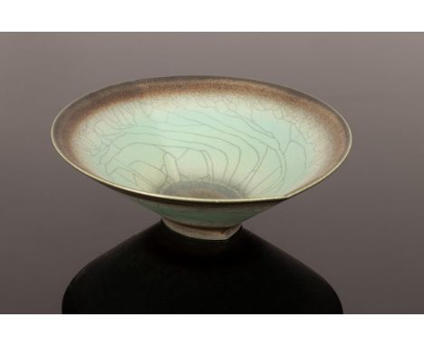 David White (Contemporary-2011), an altered ceramic footed raku dish of elliptical shape, turquoise colouring and grey rings,