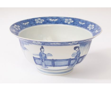 A Chinese blue and white porcelain bowl, Kangxi, depicting ladies and a boy playing in the garden, the centre of the interior