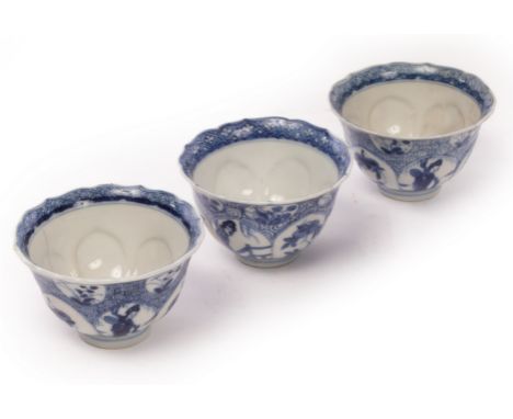 A set of three blue and white tea bowls, Qing dynasty, Kangxi period, each painted with panels of ladies and flowers, 4.5cm h