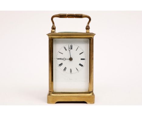 small antique travel clock in brass with a French work and with a signed plate  || E. W. STRE... reiswekker met kast in koper