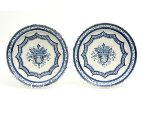 pair of 18th Cent., presumably French, dishes in ceramic with a blue-white decor with flower basket || Paar achttiende eeuwse