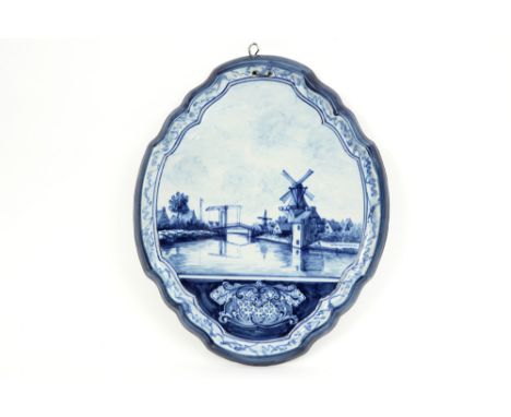 antique plaque in Dutch marked ceramic with a blue-white landscape decor || Antieke Nederlandse plaket in gemerkt faïence met
