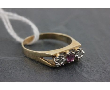 A three stone ruby and diamond ring; set in a 9ct yellow gold band