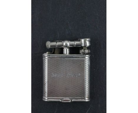A white metal Dunhill lighter