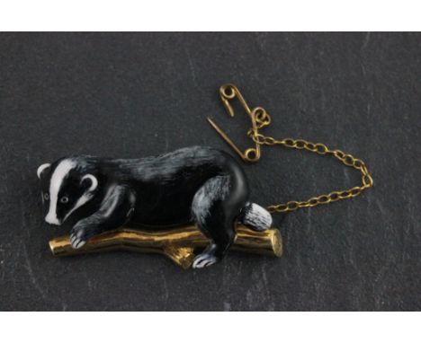 An 18ct yellow gold and enamel badger brooch