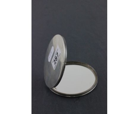 An early 20th century sterling silver compact; with engine turned decoration