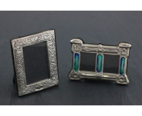 Two silver picture frames one set with enamel