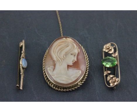 A hallmarked 9ct yellow gold opal bar brooch; a yellow metal brooch and yellow metal cameo brooch