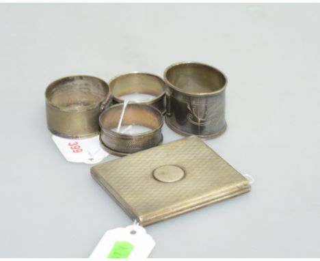 A pair of silver napkin rings, Birmingham 1931, together with two silver plated napkin rings and a silver and silver gilt cig