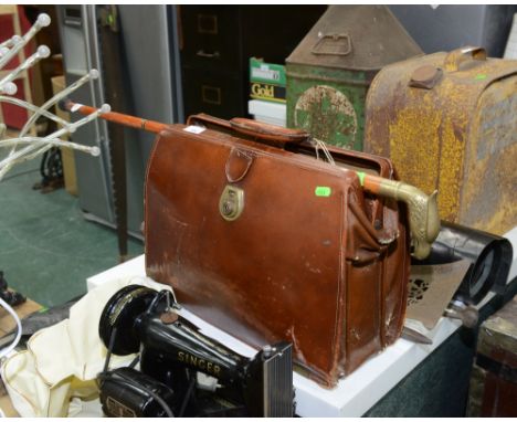 A leather briefcase; tog. with a brass handled walking stick