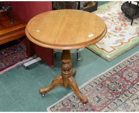 A 19th century oak circular tripod table 