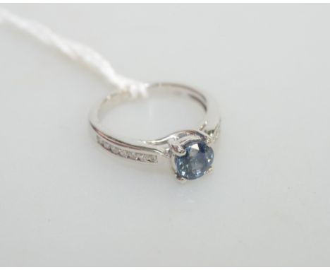 A sapphire and diamond ring, the round-cut sapphire on diamond-set shoulders, on a platinum band, sapphire approx. 1.20 carat