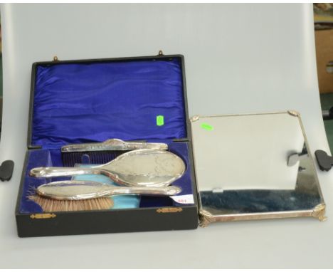 A silver backed hairbrush, mirror and comb, Birmingham 1923, in case, together with a silver plated dressing table mirror tra