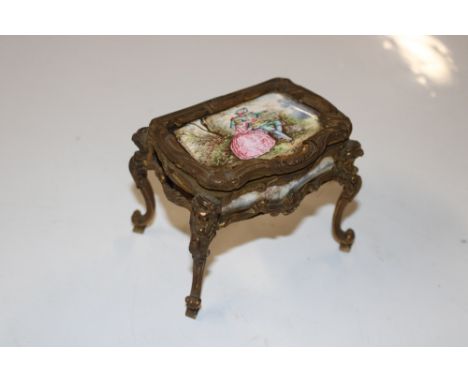 A gilt metal and enamel decorated trinket box lacking one panel