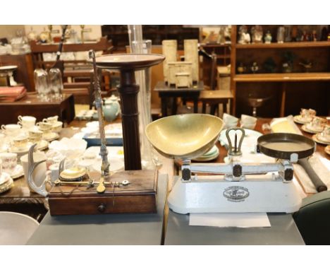 A cast iron and brass set of kitchen scales and a Victorian mahogany and brass balance scale