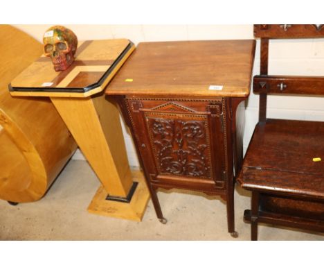 A mahogany cupboard with carved panel and chequered band inlay raised on castors AF