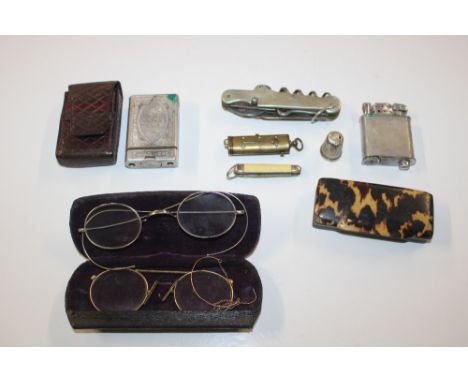 A spectacle case containing two pairs of spectacles, a tortoiseshell snuff box, cigarette lighters, pen knives etc