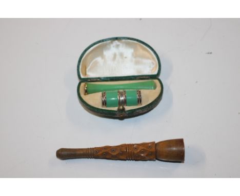A boxed miniature lighter and cheroot holder and a carved wooden cheroot holder