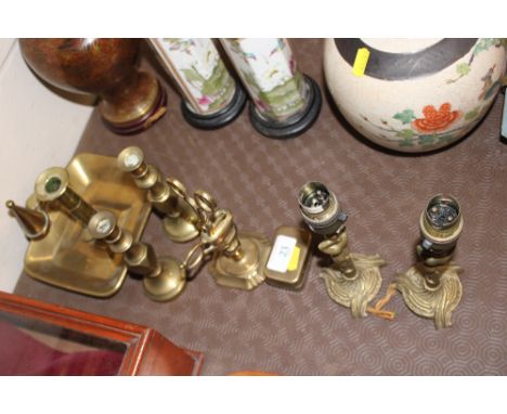 A brass chamber stick; a pair of brass candle sticks; a pair of brass table lamps etc