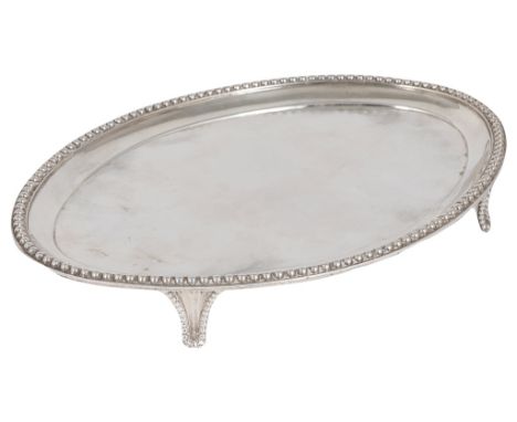 A George III Silver Teapot Stand by Peter & Anne Bateman, London 1793:of oval form with bead border and raised on four bracke