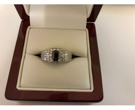 An 18ct diamond set ring with emerald cut diamond