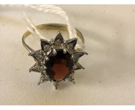 A 9ct garnet star ring